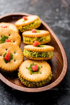 small crackers on a wooden plate with parsley and tomatoes - stock photo - images