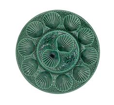 a green plate with an intricate design on it