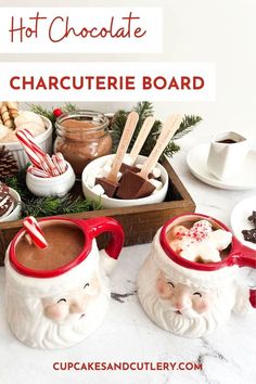 two mugs filled with hot chocolate and marshmallows on top of a table