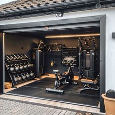 an open garage door with exercise equipment inside