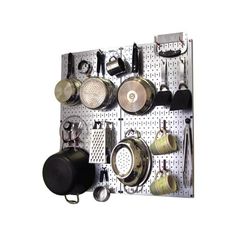 a peg board with pots and pans hanging on it