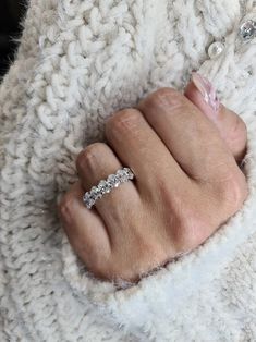 a woman's hand wearing a diamond ring