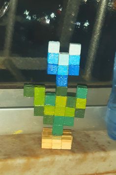 a toy made out of blocks sitting on top of a window sill