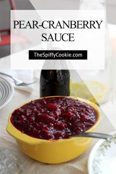 a yellow bowl filled with cranberry sauce on top of a table