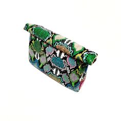 DETAILS Multi-colored snake print Fold to close Magnetic closure Soft Polyurethane Material Faux leather clutch bag DESCRIPTION Faux leather vibrant multi-colored clutch bag with fold to close magnetic clasp. This bag is easy to carry and holds just the right amount of items on a night out . The inside of the purse is a simple open storage area without pockets. This bag is soft and has a leather feel. SIZING 10L x 3W x 9.5H in Multicolor Evening Clutch With Removable Pouch, Trendy Multicolor Clutch Evening Bag, Multicolor Shoulder Bag With Magnetic Closure For Evening, Party Multicolor Clutch With Removable Pouch, Multicolor Party Clutch With Removable Pouch, Trendy Green Leather Clutch, Multicolor Leather Rectangular Clutch, Multicolor Rectangular Leather Clutch, Trendy Multicolor Clutch Wallet