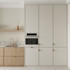 a kitchen with an oven, sink and cabinets