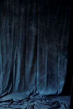 an image of a blue curtain that looks like it has been drapeed in