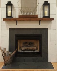 a fireplace with two candles on top of it