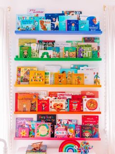 the colorful bookshelf is filled with children's books