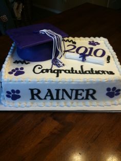 a cake with a graduation cap and paw prints on it