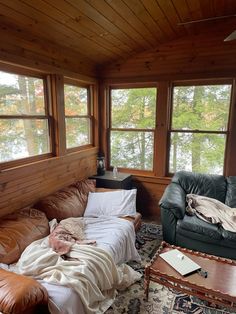 a living room filled with furniture and lots of windows