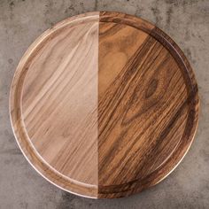 two wooden plates sitting side by side on concrete