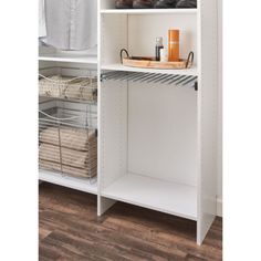 an organized closet with white shelves and baskets