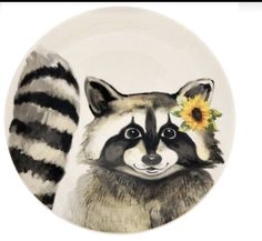 a plate with a raccoon and a sunflower on the side, painted in black and white