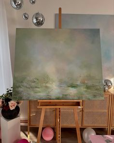 an easel with a large painting on it