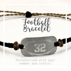 a football bracelet with the number 32 engraved on it and brown cord, is shown in front of a white background