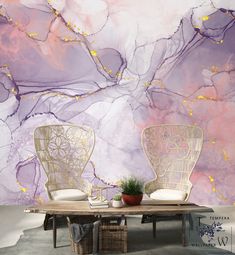 two chairs sitting on top of a wooden table in front of a purple and white wall