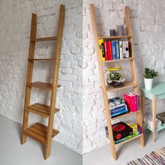 two wooden shelves with books on them next to a white brick wall