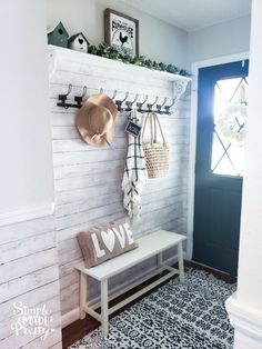 a white bench sitting next to a blue door in a room with black and white flooring