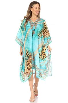 This caftan dress cover up features a beautiful handmade cut. It has a beautiful multi toned tribal pattern print with a v-neck and rhinestone embellishments around the neckline. The dress is long and tall, and has adjustable drawstrings at the neckline that can be left undone or tied as desired. The dress is very lightweight and airy.