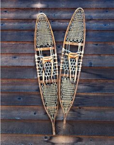 two wooden sleds are hanging on the wall