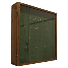 an old wooden box with writing on the inside and green glass in the outside, isolated against a white background