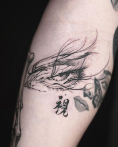 a woman's arm with tattoos and writing on it