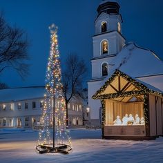 a lit up christmas tree in front of a church