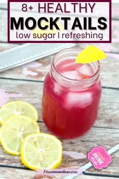 a mason jar filled with lemonade next to sliced lemons