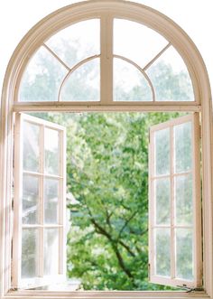 an open window with the view of trees outside