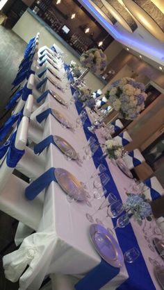 the tables are set up with blue and white linens