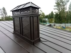 a metal roof with a cupola on top