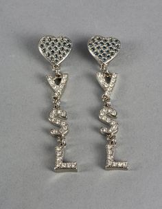 Features: - 100% Authentic YVES SAINT LAURENT. - Long YSL heart and initial drop earrings embellished with blue and clear rhinestones. - Silver tone hardware. - Clip back earrings. - Signed YSL Made in France. - Excellent vintage condition. Measurements: Height: 3.54 inches (9 cm) Width: 0.82 inch (2.1 cm) Weight per Earring: 16 grams **These earrings will be shipped via DHL Express Shipping with tracking number. Please convo me for any queries and additional photos. Thank you for visiting. Othe Vintage Yves Saint Laurent, Heart Rhinestone, Vintage Ysl, Jeweled Earrings, Dangling Earrings, Rhinestone Earrings, Earrings Photo, Arabesque, Clear Rhinestones