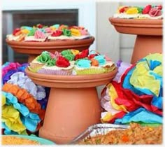 there are many cupcakes on top of the cake dishes in front of each other