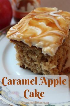 a close up of a piece of cake on a plate with apples in the background