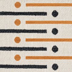 an orange, black and white rug with circles on it