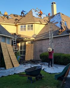 men working on the roof of a house