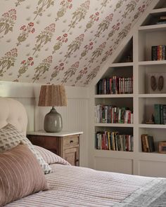 a bedroom with bookshelves and a bed in it