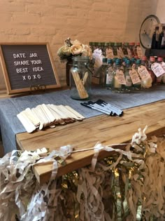 a wooden table topped with lots of paper streamers next to a sign that says save air share your best idea