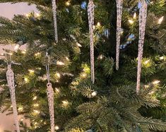 a christmas tree with icicles hanging from it's branches