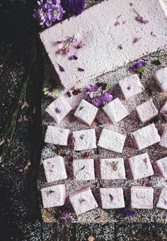 there are many squares of food on the ground next to some purple flowers and lavenders