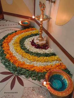 a decorated floor with candles and flowers on it