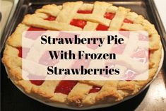 a strawberry pie with frozen strawberries in it on top of a baking pan and the words, strawberry pie with frozen strawberries