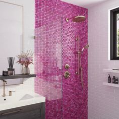 a bathroom with pink tiles on the shower wall