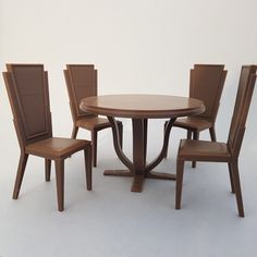 a table with four chairs around it on a white background in front of a wall