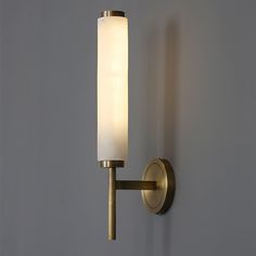 a wall light that is on the side of a wall next to a gray wall