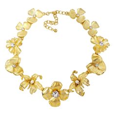 Glowing feminine beauty! This satin gold flower collar necklace with crystal and white faux pearl centers elevates any look with sparkling, blooming flowers cast in a golden gleam. Length 14.5 in / 37 cm plus 3.25 in / 8.5 cm extension Necklaces Flower, Gold Flower Necklace, Flower Collar, Multi Strand Beaded Necklace, Elephant Pendant Necklace, Hook Necklace, Flower Statement Necklace, Jewelry Flower, Necklace Flower