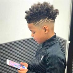 We know finding the perfect haircut can be tough, especially when there are so many styles to choose from. When it comes to choosing a haircut for your son,#boyhair #boysstyle #kidshair #trendyboys #coolhair #boyscut #hairstyleideas #littleman #hairinspo #boysfashion Black Boys Haircuts Kids, Kids Fade Haircut, Trending Boys Haircuts, Mixed Boys Haircuts, Boys Haircuts Curly Hair, Hair Designs For Boys, Boys Haircuts With Designs, Boys Curly Haircuts, Black Boy Hairstyles