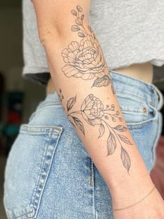 a woman with a flower tattoo on her arm