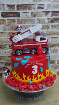 a birthday cake with a fire truck on top